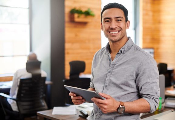 Man with tablet smiling