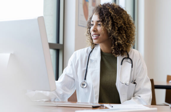 Female doctor reviewing information on a computer screen