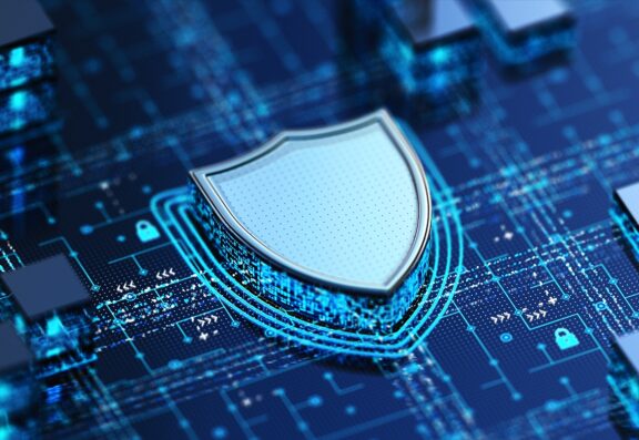 Digital shield icon on a circuit board representing cybersecurity and data protection for small and medium businesses